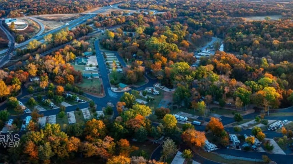Aerial view of RiverView RV & Recreational Park surrounded by colorful fall trees in Colbert, Oklahoma